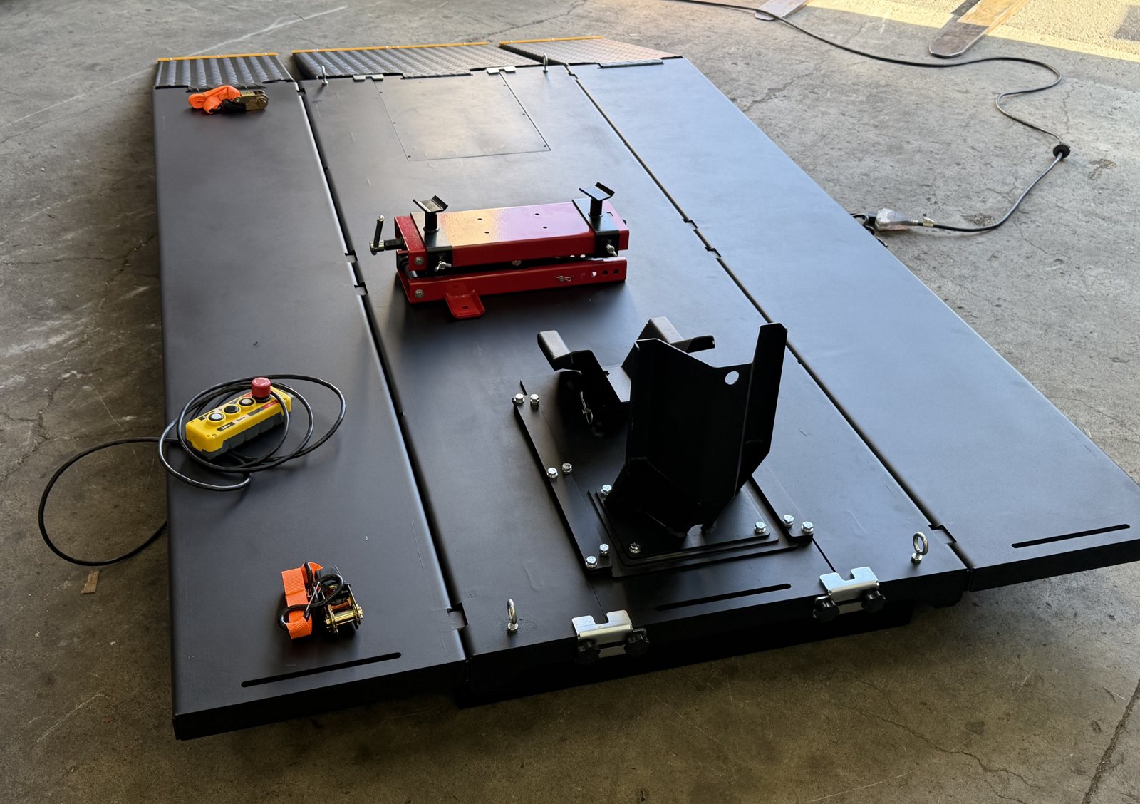 Deck of the Performance Hoist Motorcycle/ATV Lift with the lifting jack and front wheel chock