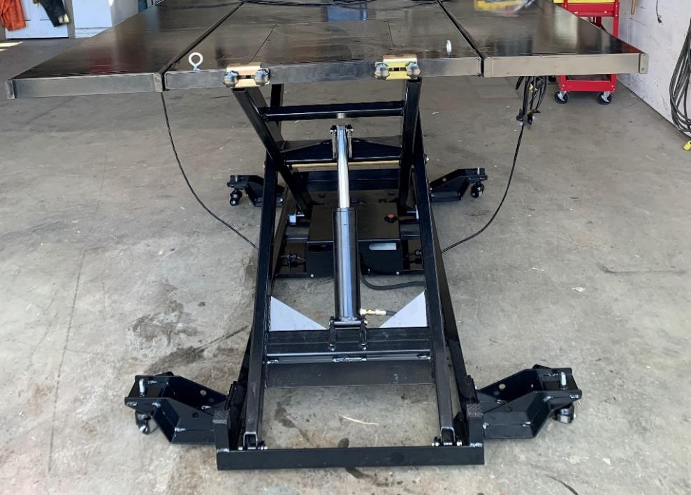 Performance Hoist motorcycle and ATV lift raised on its castors in the SVI shop