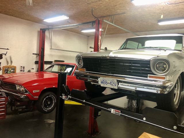 Classic Chevrolet raised on the Atlas PH8S four-post lift during a home garage install near Miracle Beach