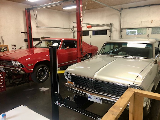 Home garage near Miracle Beach BC with classic cars and an Atlas PH8S four-post parking lift installed by SVI