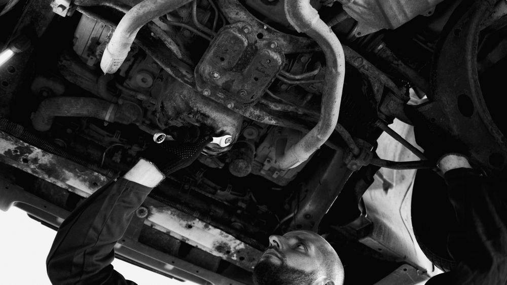 Technician servicing a vehicle on a lift